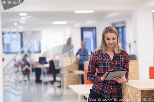 Image of portrait of young business woman at office with team in backgrou