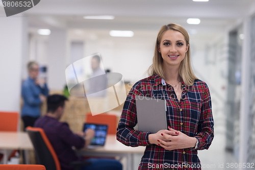 Image of portrait of young business woman at office with team in backgrou