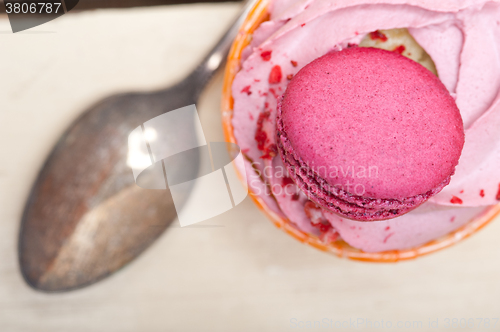 Image of pink berry cream cupcake with macaroon on top