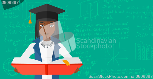 Image of Woman in graduation cap holding book.