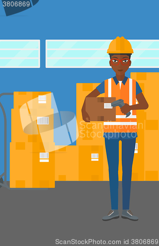 Image of Worker checking barcode on box.