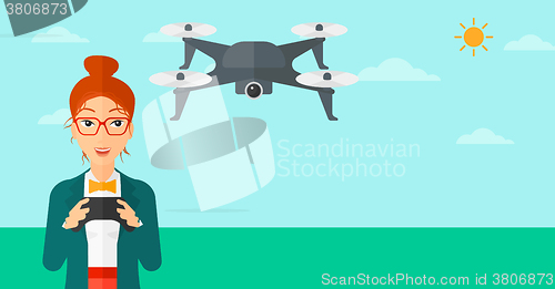 Image of Woman flying drone.