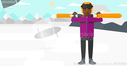 Image of Man holding skis.