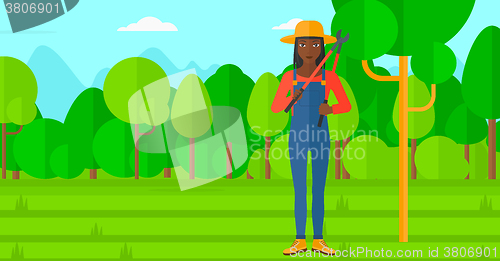 Image of Farmer with pruner in garden.