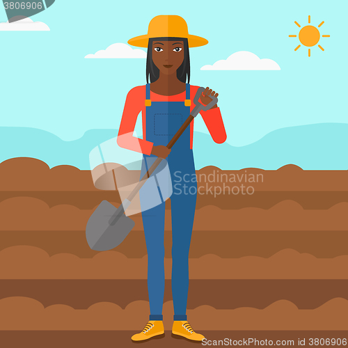 Image of Farmer on the field with shovel.