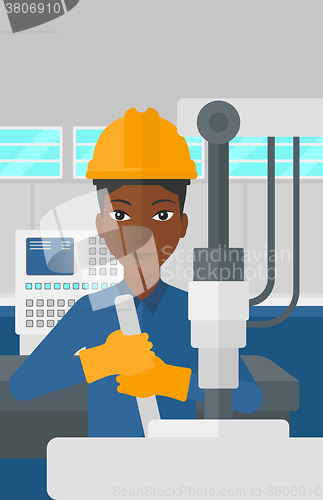 Image of Woman working with industrial equipment.