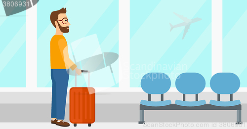 Image of Man at airport with suitcase.