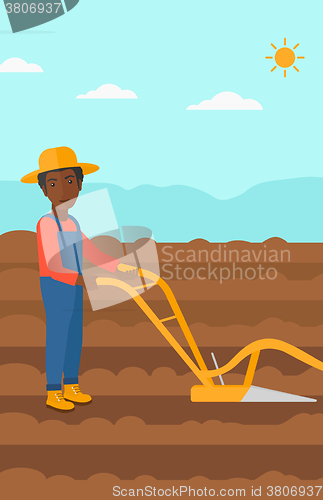 Image of Farmer on the field with plough.