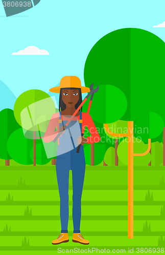 Image of Farmer with pruner in garden.