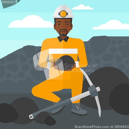 Image of Miner holding coal in hands.