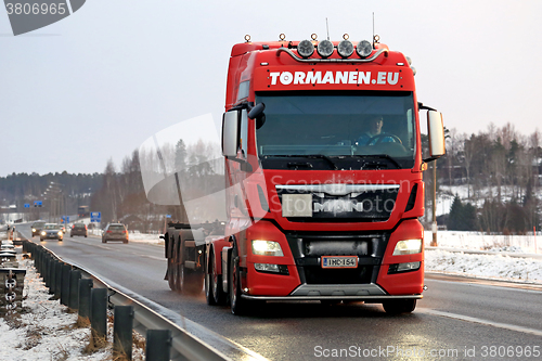 Image of Red MAN Truck Bobtails along Highway