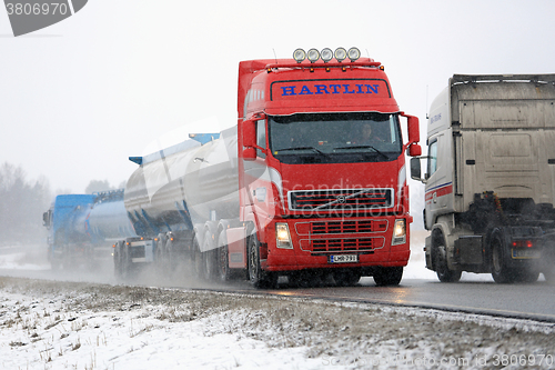 Image of Busy Truck Traffic in Snowfall 