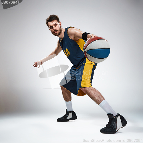 Image of Full length portrait of a basketball player with ball 