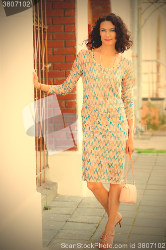 Image of beautiful smiling woman on the ancient street