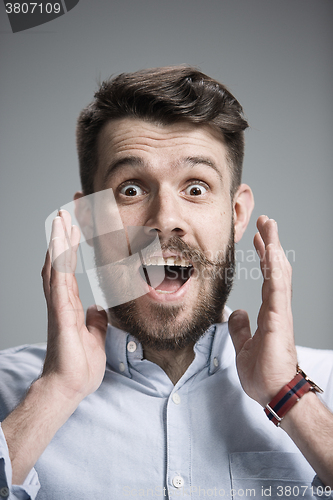 Image of Portrait of young man with shocked facial expression