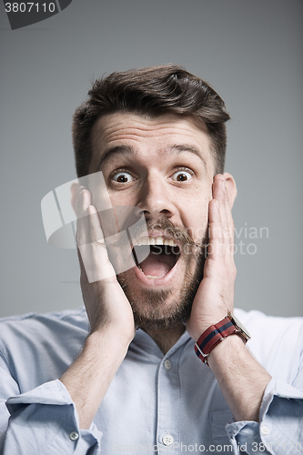 Image of Portrait of young man with shocked facial expression