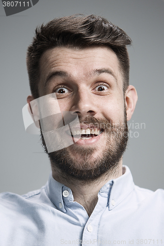 Image of Portrait of young man with shocked facial expression