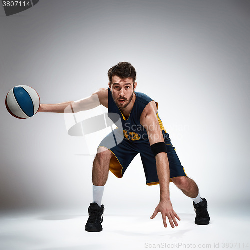 Image of Full length portrait of a basketball player with ball 