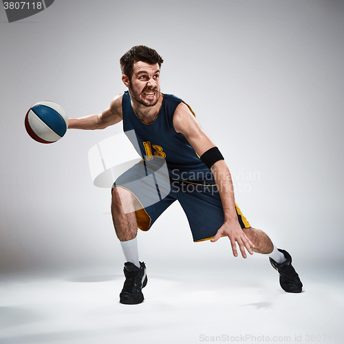 Image of Full length portrait of a basketball player with ball 