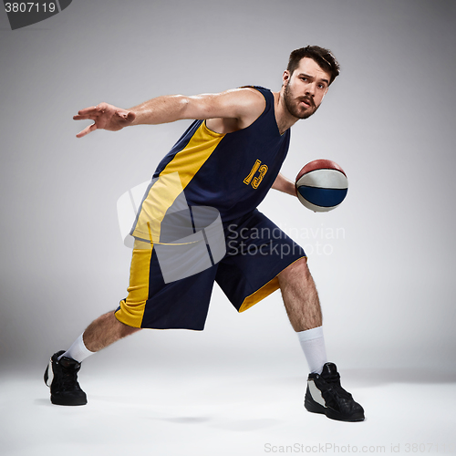 Image of Full length portrait of a basketball player with ball 