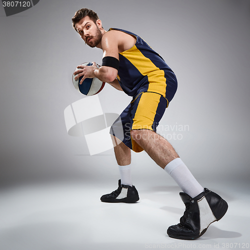 Image of Full length portrait of a basketball player with ball 