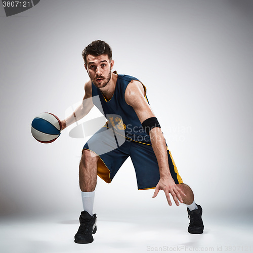 Image of Full length portrait of a basketball player with ball 