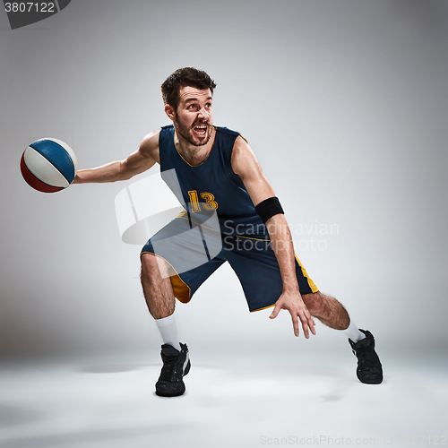 Image of Full length portrait of a basketball player with ball 