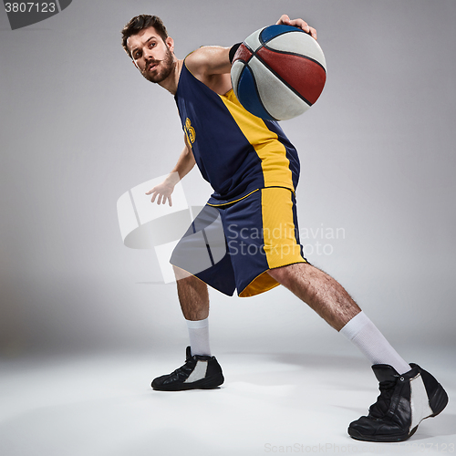 Image of Full length portrait of a basketball player with ball 