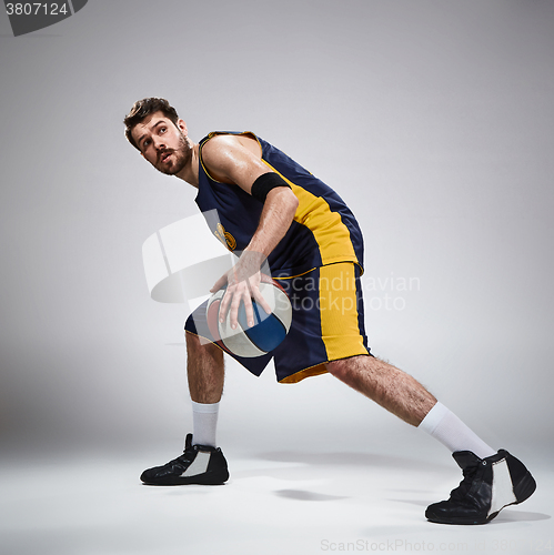 Image of Full length portrait of a basketball player with ball 