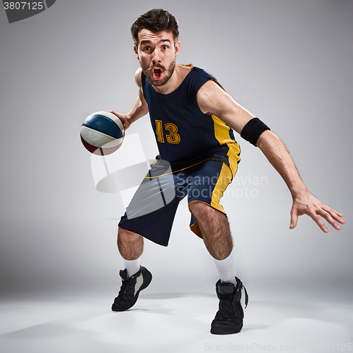 Image of Full length portrait of a basketball player with ball 