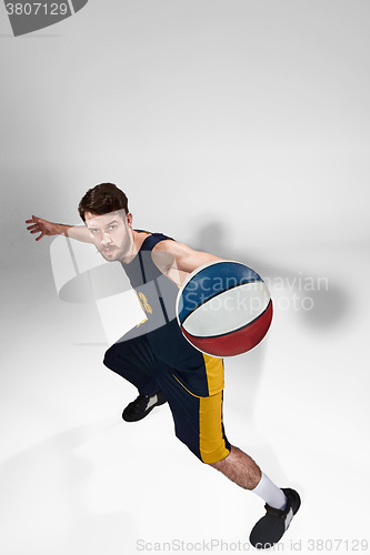 Image of Full length portrait of a basketball player with ball 