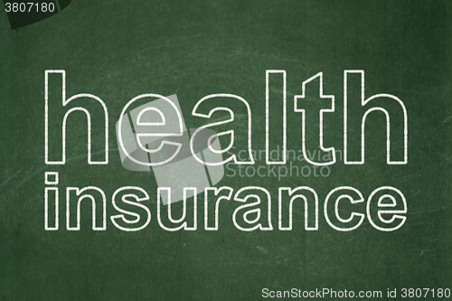 Image of Insurance concept: Health Insurance on chalkboard background