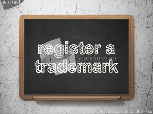 Image of Law concept: Register A Trademark on chalkboard background