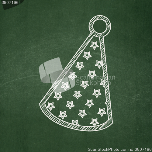 Image of Holiday concept: Party Hat on chalkboard background