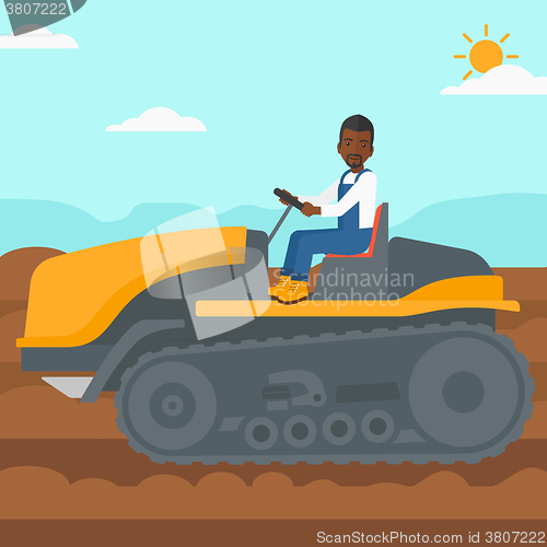 Image of Farmer driving catepillar tractor.