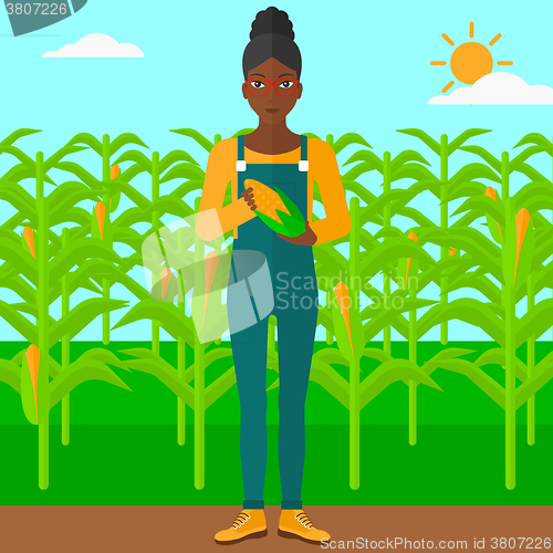 Image of Farmer holding corn.