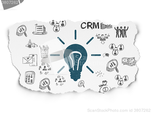 Image of Finance concept: Light Bulb on Torn Paper background