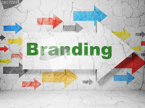 Image of Advertising concept: arrow with Branding on grunge wall background