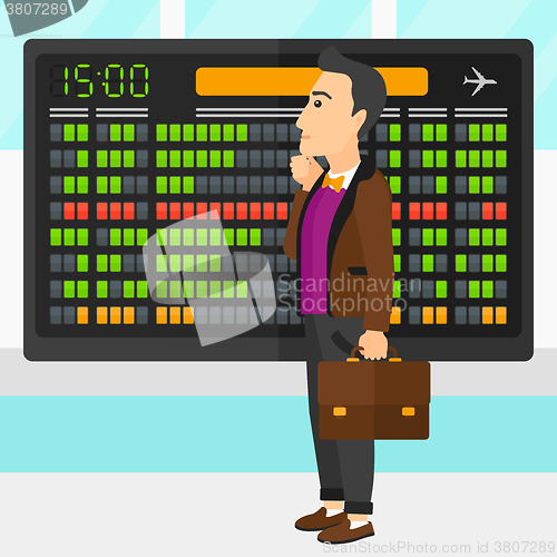 Image of Man looking at schedule board.