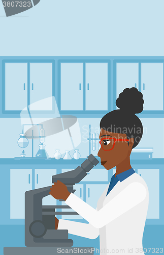 Image of Laboratory assistant with microscope.