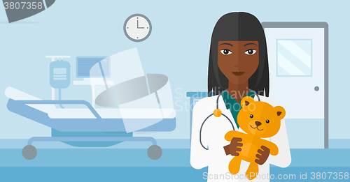 Image of Pediatrician holding teddy bear.