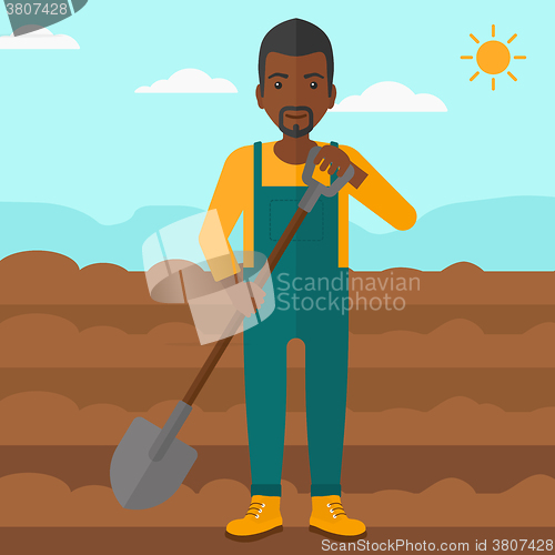 Image of Farmer on the field with shovel.