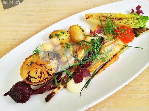 Image of Gourmet dish with grilled fish and vegetables