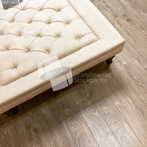 Image of Fancy ottoman on wooden floor