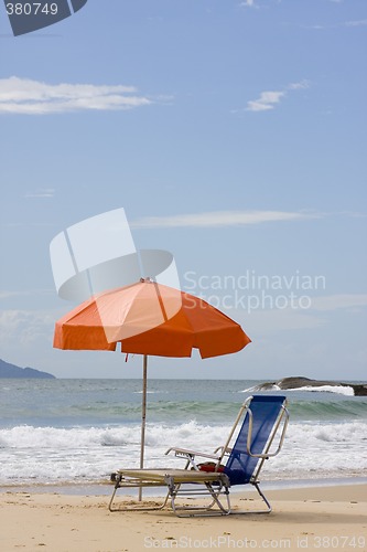 Image of Chairs and parasol on beach