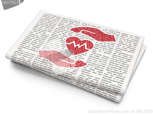 Image of Insurance concept: Heart And Palm on Newspaper background