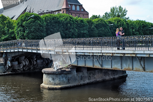 Image of Family stand on Medovy Bridge. Kaliningrad.Russia