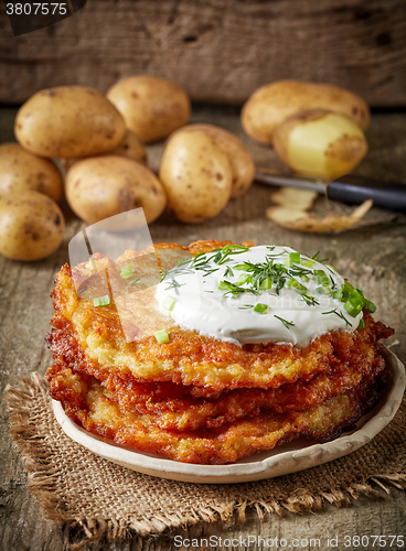 Image of Potato pancakes on wooden table