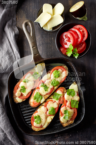 Image of Baked eggplant with tomatoes and cheese