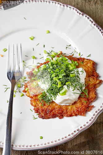 Image of potato pancake on white plate